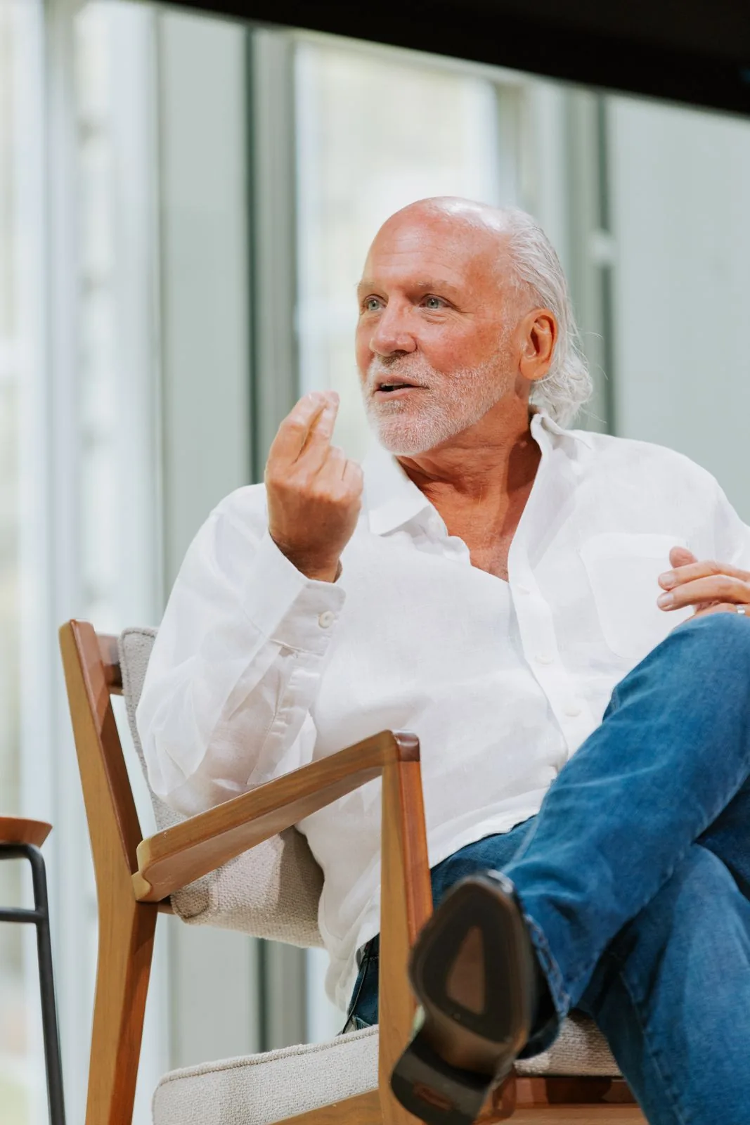 Dennis in a white shirt, mid-conversation on stage at The TimesCenter, New York