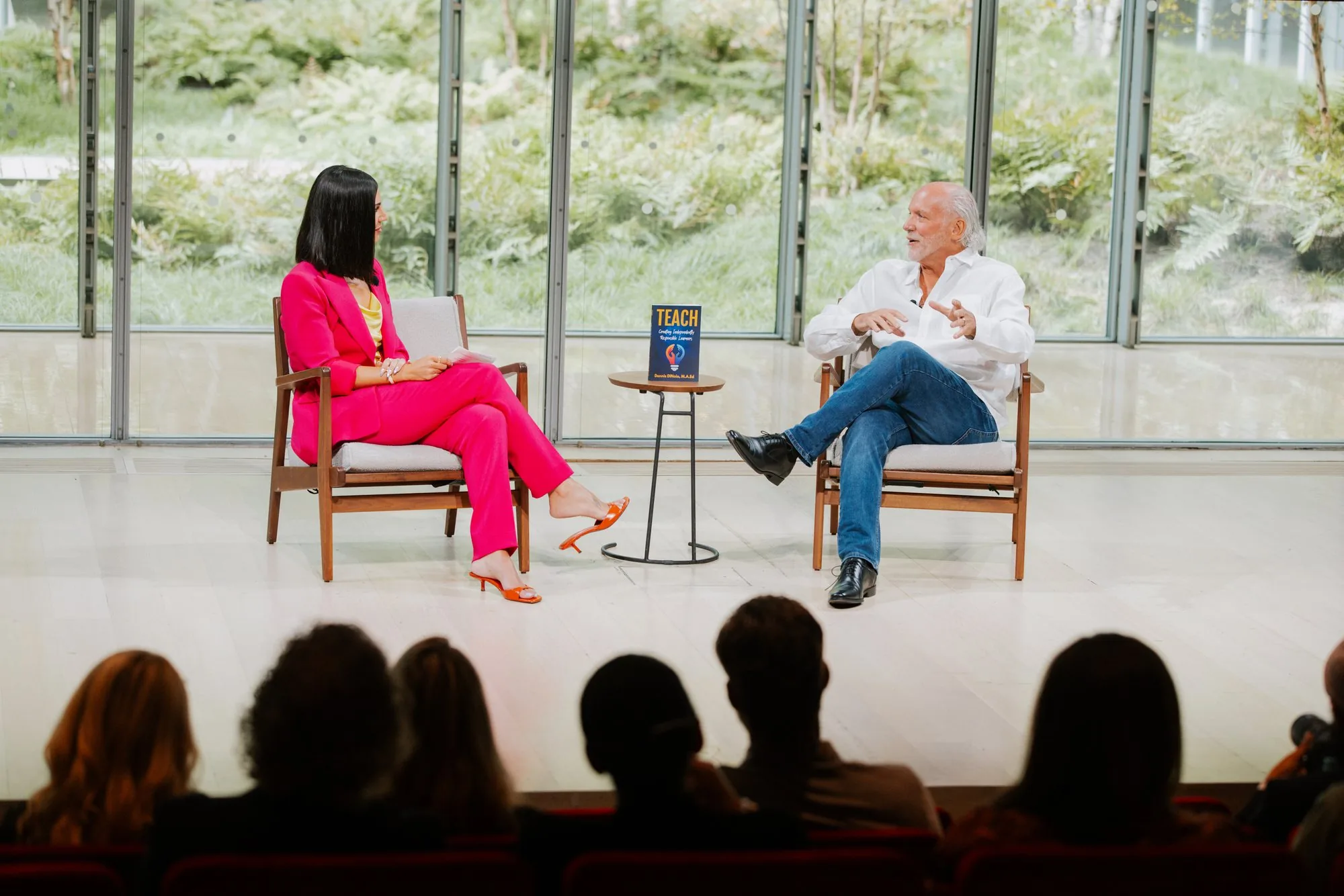 Dennis in conversation on stage at The TimesCenter, New York, his book TEACH on the table between the two chairs