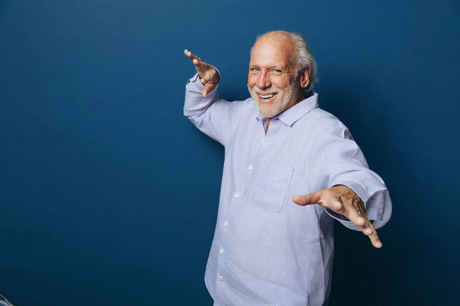 Dennis DiNoia in a navy jacket, mid-gesture